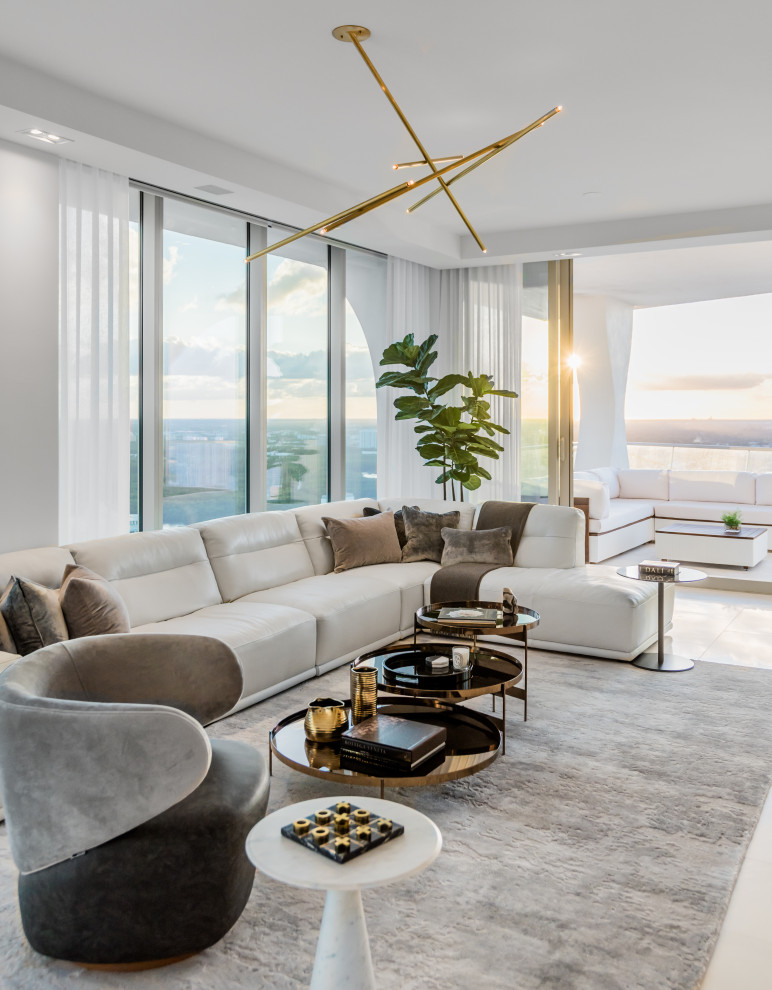 Design ideas for a large contemporary open concept living room in Miami with grey walls, porcelain floors and beige floor.