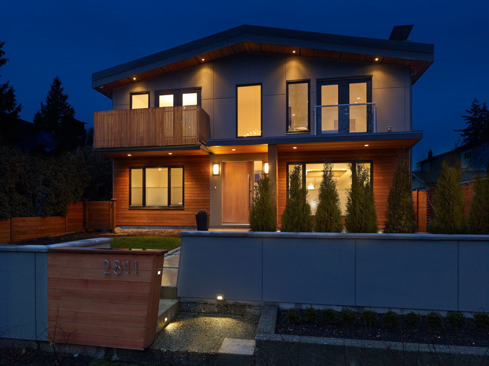 This is an example of a contemporary two-storey grey exterior in Vancouver with concrete fiberboard siding.