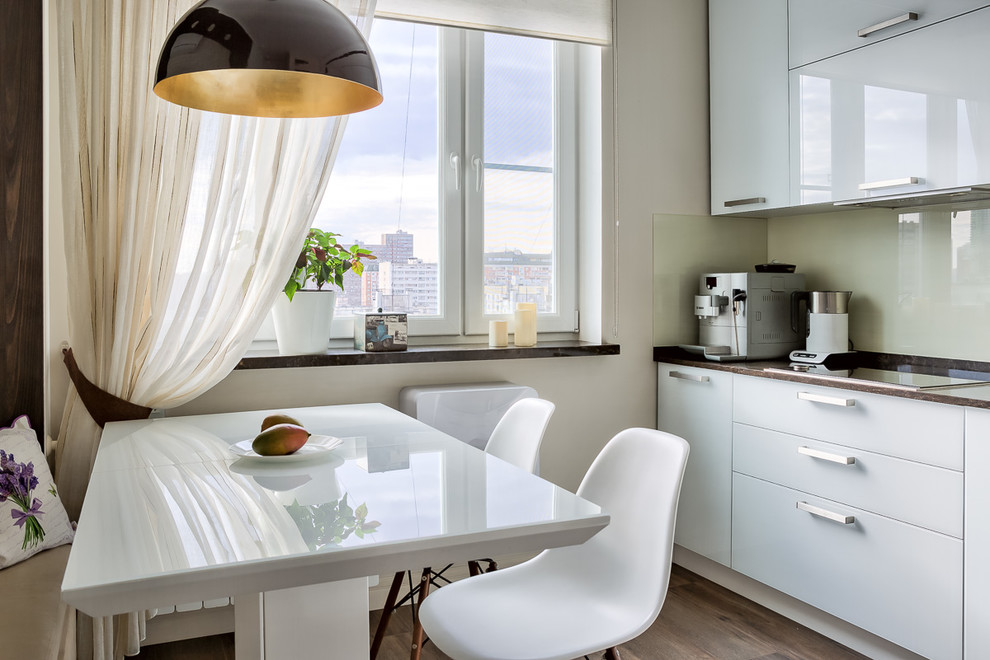 Photo of a small contemporary single-wall eat-in kitchen in Moscow with an integrated sink, flat-panel cabinets, white cabinets, quartz benchtops, beige splashback, glass sheet splashback, white appliances, porcelain floors, no island, brown floor and brown benchtop.