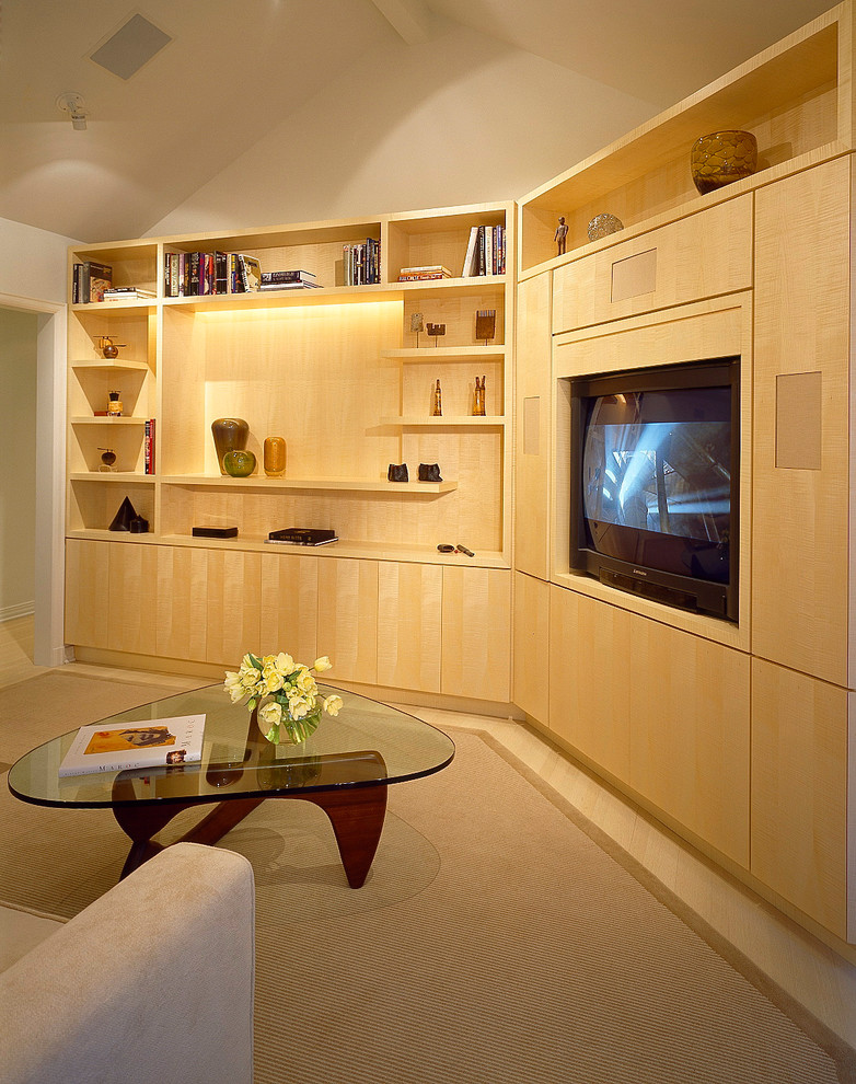 Photo of a mid-sized contemporary enclosed home theatre in Los Angeles with white walls, light hardwood floors and a built-in media wall.