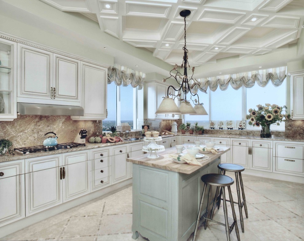 Inspiration for an expansive traditional l-shaped eat-in kitchen in Miami with an undermount sink, raised-panel cabinets, beige cabinets, granite benchtops, brown splashback, stone slab splashback, stainless steel appliances, travertine floors, with island, beige floor and brown benchtop.
