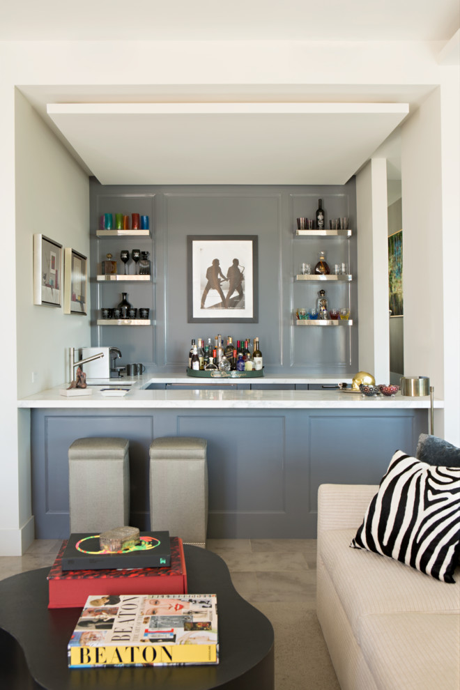 Mid-sized eclectic u-shaped seated home bar in Los Angeles with concrete floors, an undermount sink, recessed-panel cabinets, grey cabinets, grey splashback, beige floor and white benchtop.
