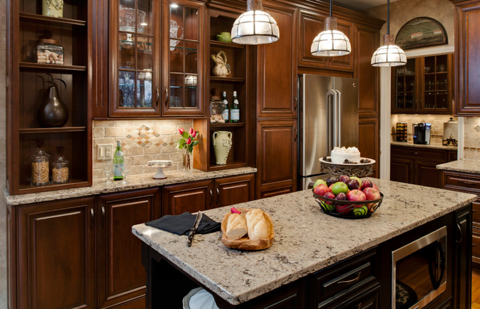 Example of a small transitional medium tone wood floor and brown floor open concept kitchen design in Toronto with raised-panel cabinets, dark wood cabinets, granite countertops, beige backsplash, ceramic backsplash, stainless steel appliances and an island