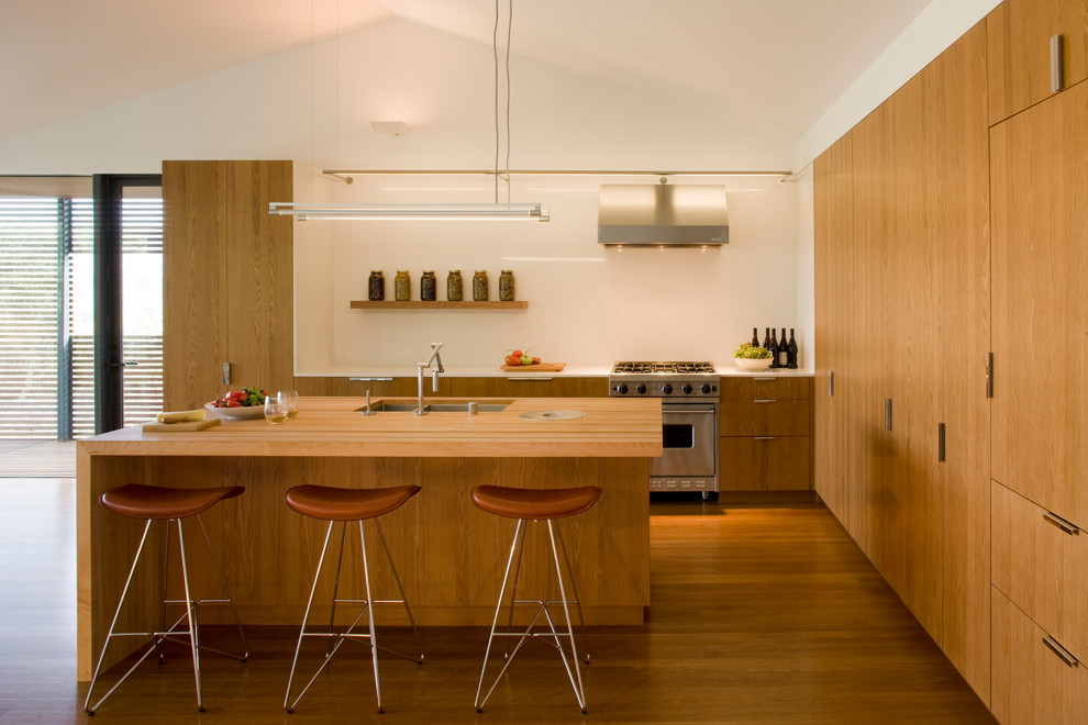 Inspiration for a contemporary kitchen remodel in San Francisco with flat-panel cabinets, medium tone wood cabinets, wood countertops and stainless steel appliances