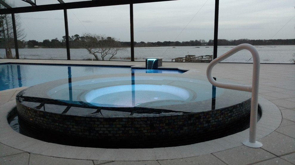Mid-sized contemporary indoor custom-shaped lap pool in Orlando with concrete pavers and a hot tub.