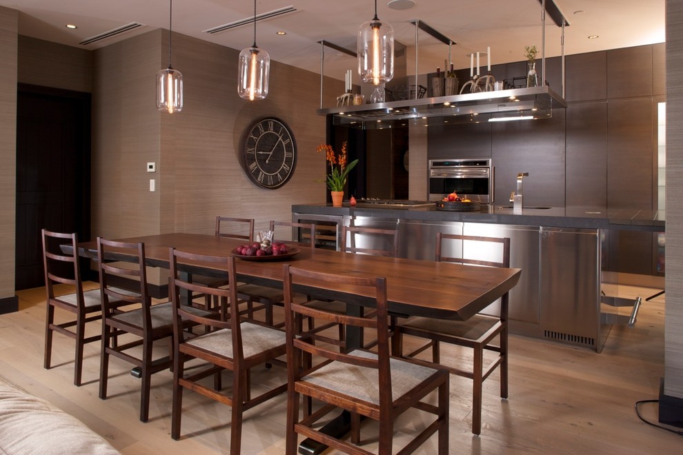 This is an example of a transitional kitchen/dining combo in Denver with medium hardwood floors.