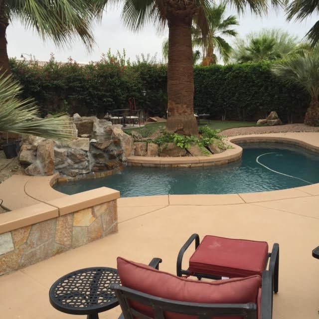Pool fountain - mid-sized backyard concrete paver pool fountain idea
