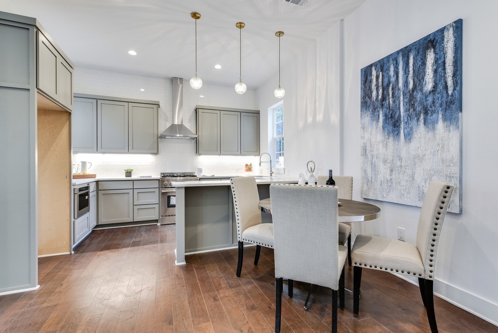 Small transitional u-shaped light wood floor and brown floor open concept kitchen photo in Austin with a single-bowl sink, shaker cabinets, gray cabinets, quartz countertops, white backsplash, subway tile backsplash, stainless steel appliances and yellow countertops