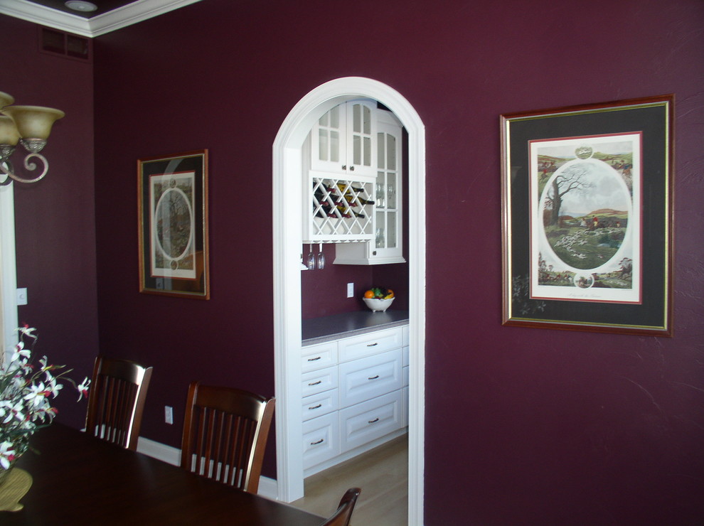 Design ideas for a mid-sized traditional separate dining room in Milwaukee with purple walls and light hardwood floors.