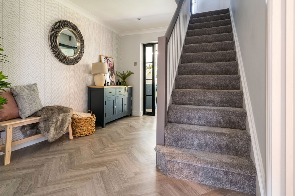 Inspiration for a mid-sized modern hallway in West Midlands with grey walls, vinyl floors, grey floor and wallpaper.