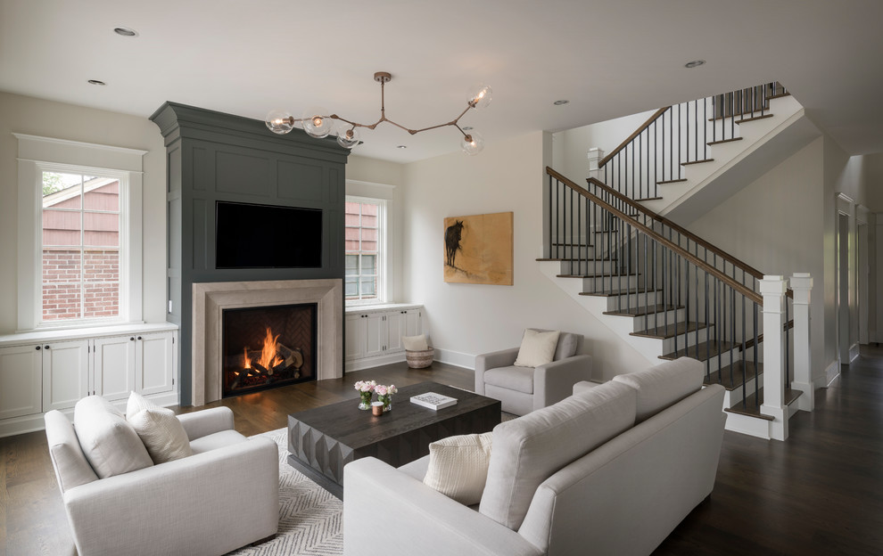 Design ideas for a transitional open concept living room in Seattle with white walls, dark hardwood floors, a standard fireplace and brown floor.