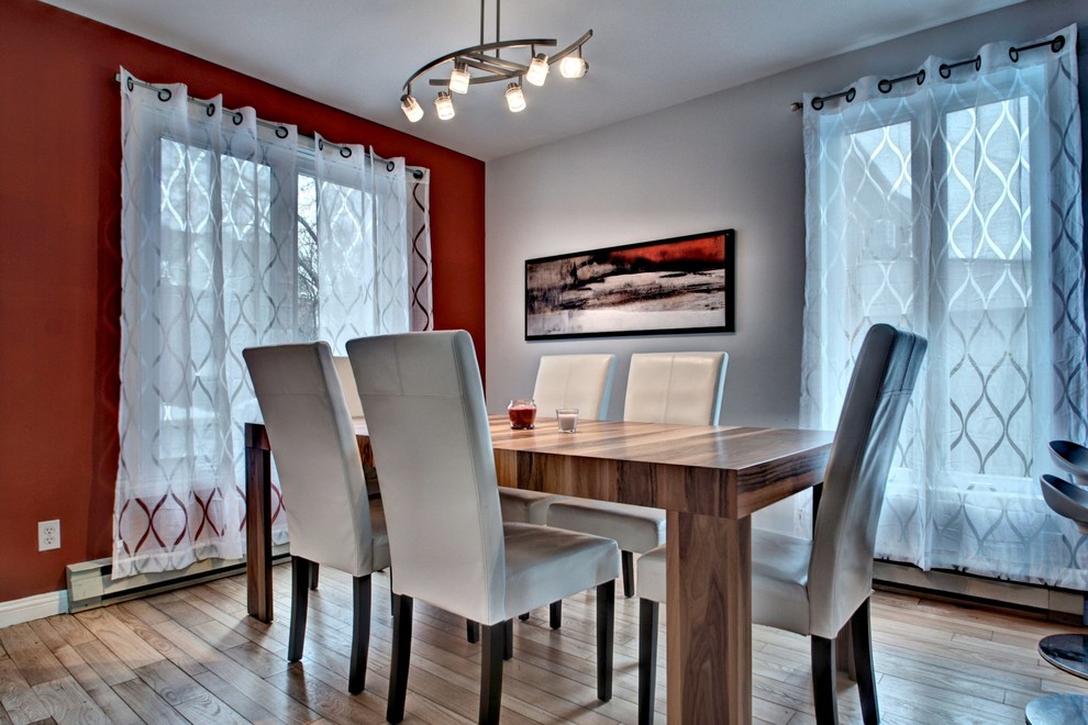 Design ideas for a small contemporary dining room in Montreal with light hardwood floors.