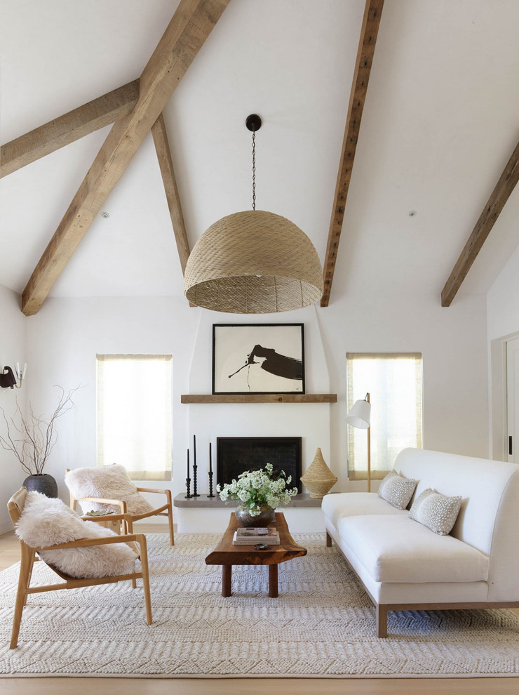 Inspiration for an expansive transitional open concept living room in San Francisco with white walls, light hardwood floors, a standard fireplace, a plaster fireplace surround, no tv, beige floor and exposed beam.