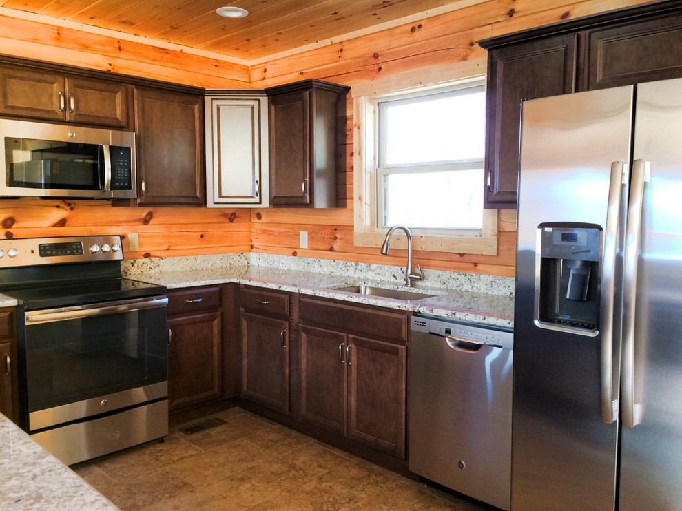 Mid-sized mountain style u-shaped porcelain tile eat-in kitchen photo with a single-bowl sink, dark wood cabinets and granite countertops