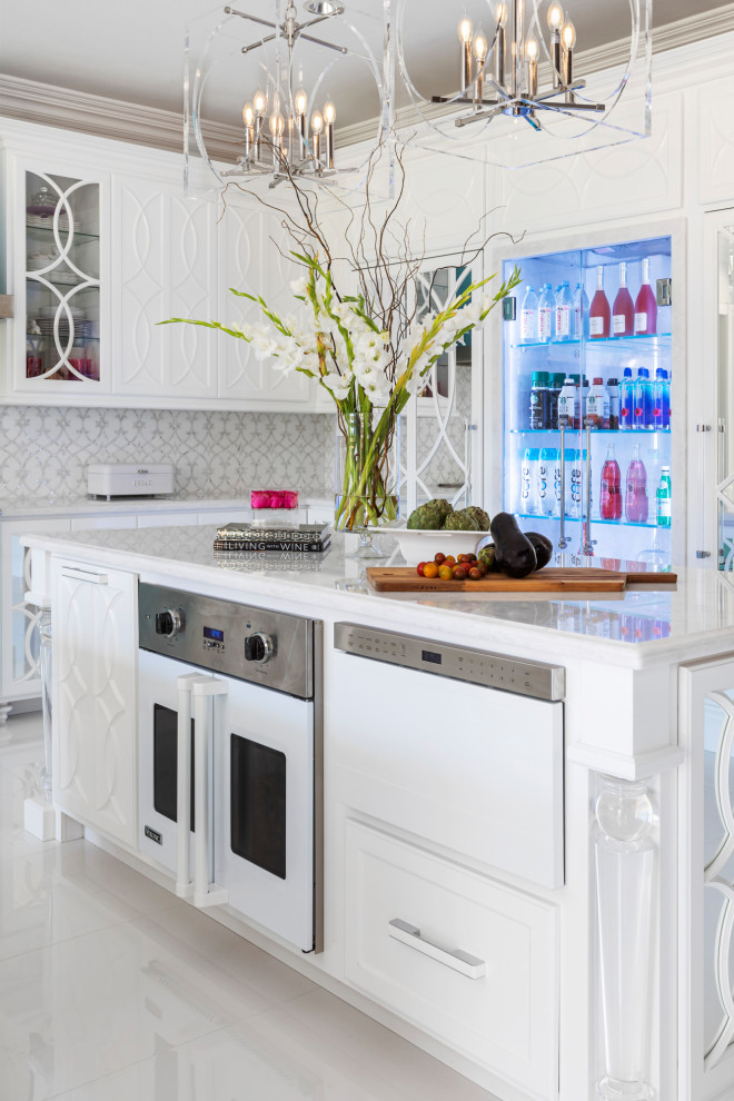 Inspiration for a large transitional u-shaped eat-in kitchen in Orange County with glass-front cabinets, white cabinets, marble benchtops, metallic splashback, mosaic tile splashback, coloured appliances, multiple islands and white benchtop.