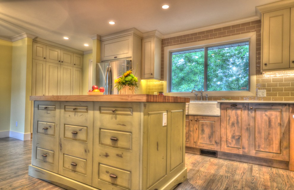 Inspiration for a rustic medium tone wood floor kitchen remodel in Calgary with raised-panel cabinets, distressed cabinets, a farmhouse sink, wood countertops, stainless steel appliances and an island