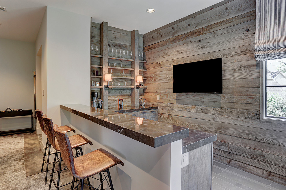 This is an example of a transitional l-shaped wet bar in Houston with shaker cabinets, distressed cabinets, timber splashback and grey floor.