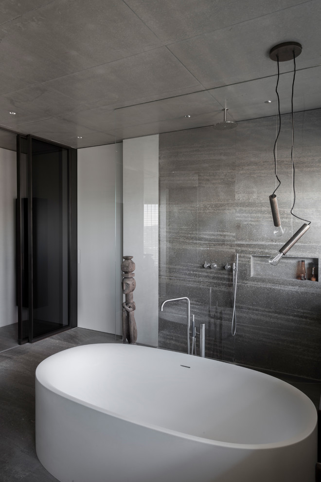 Inspiration for a mid-sized industrial 3/4 bathroom in Stuttgart with a freestanding tub, an open shower, beige tile, gray tile, concrete floors, grey floor and an open shower.