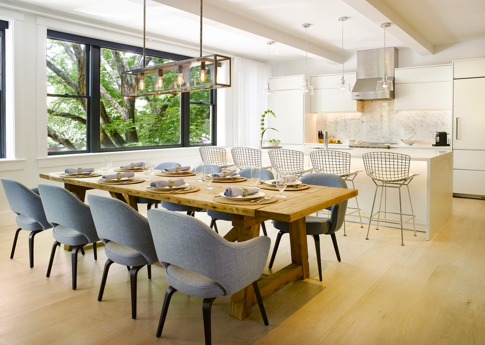 Contemporary dining room in Boston with white walls and light hardwood floors.