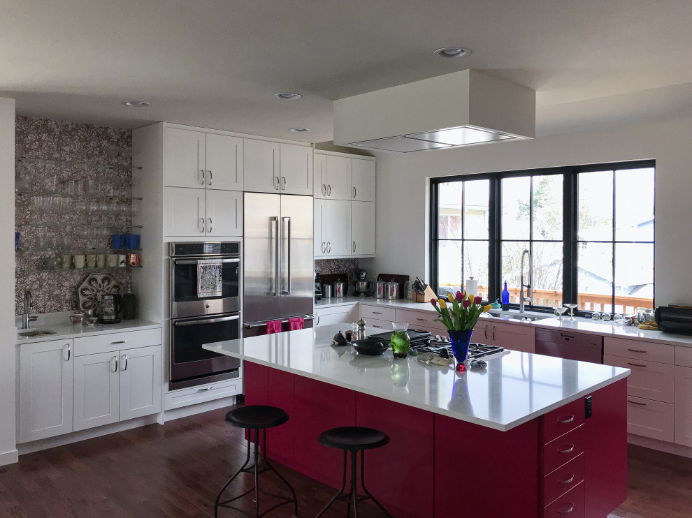 Eat-in kitchen - mid-sized transitional l-shaped dark wood floor eat-in kitchen idea in Seattle with an undermount sink, shaker cabinets, pink cabinets, quartz countertops, metallic backsplash, stainless steel appliances, an island and white countertops