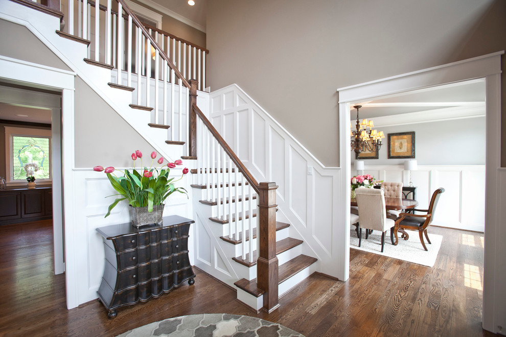 Example of a mid-sized transitional medium tone wood floor foyer design in Cincinnati with gray walls
