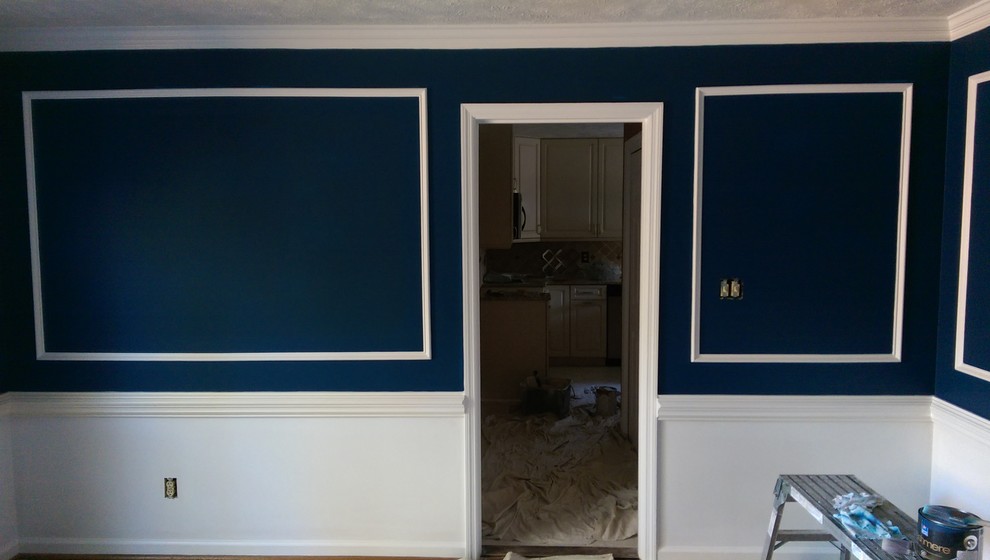 Mid-sized dark wood floor enclosed dining room photo with blue walls and no fireplace