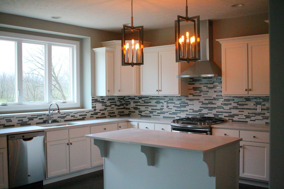 Example of a mid-sized transitional dark wood floor kitchen design in Chicago with an undermount sink, shaker cabinets, white cabinets, solid surface countertops, multicolored backsplash, glass tile backsplash, stainless steel appliances and an island