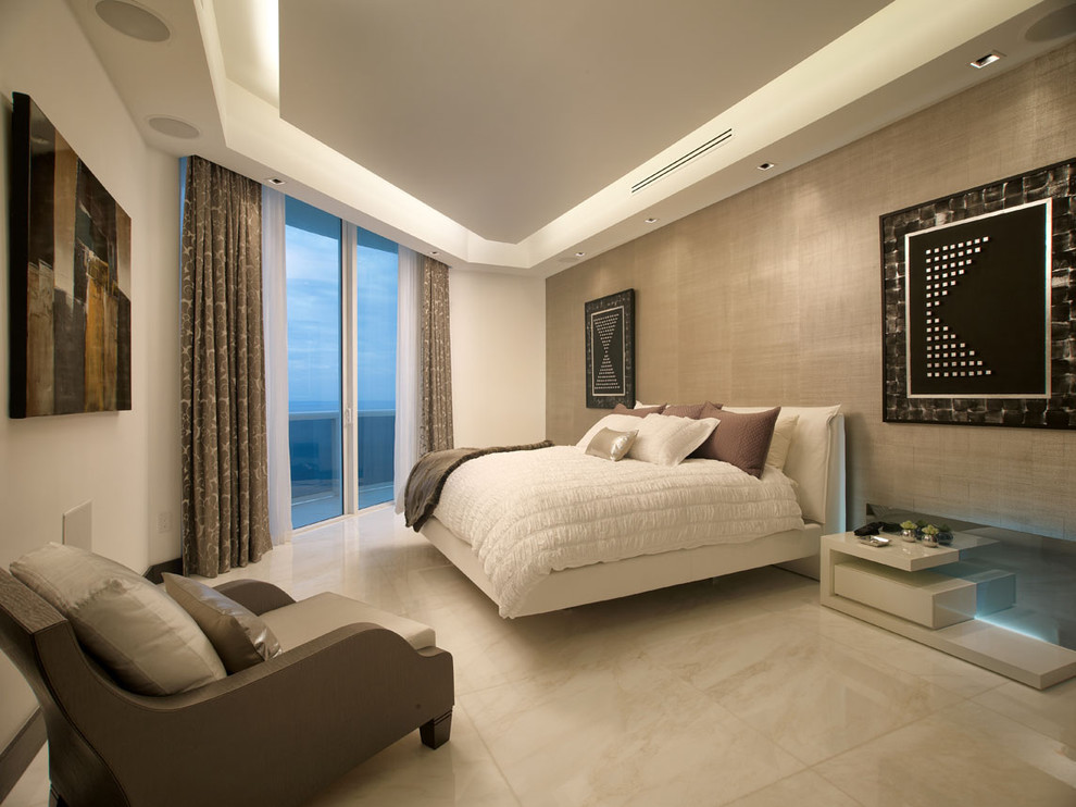 Inspiration for a contemporary bedroom in Miami with beige walls, marble floors and beige floor.