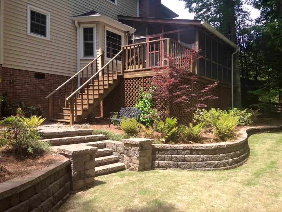 This is an example of a large traditional backyard deck in Other with a container garden and a roof extension.