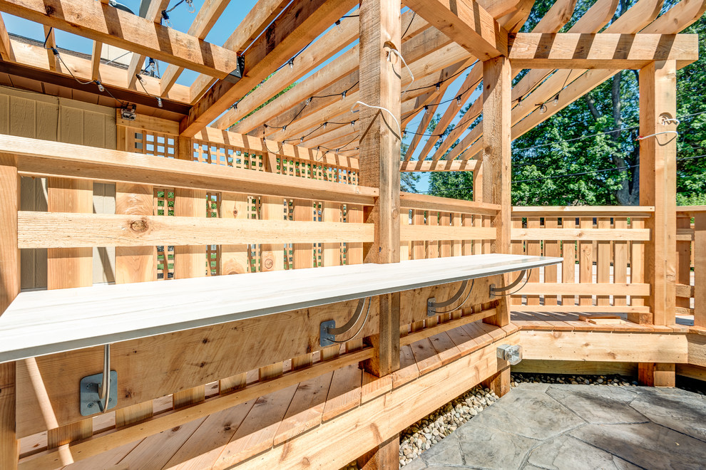 Deck - large transitional backyard deck idea in Chicago with a pergola