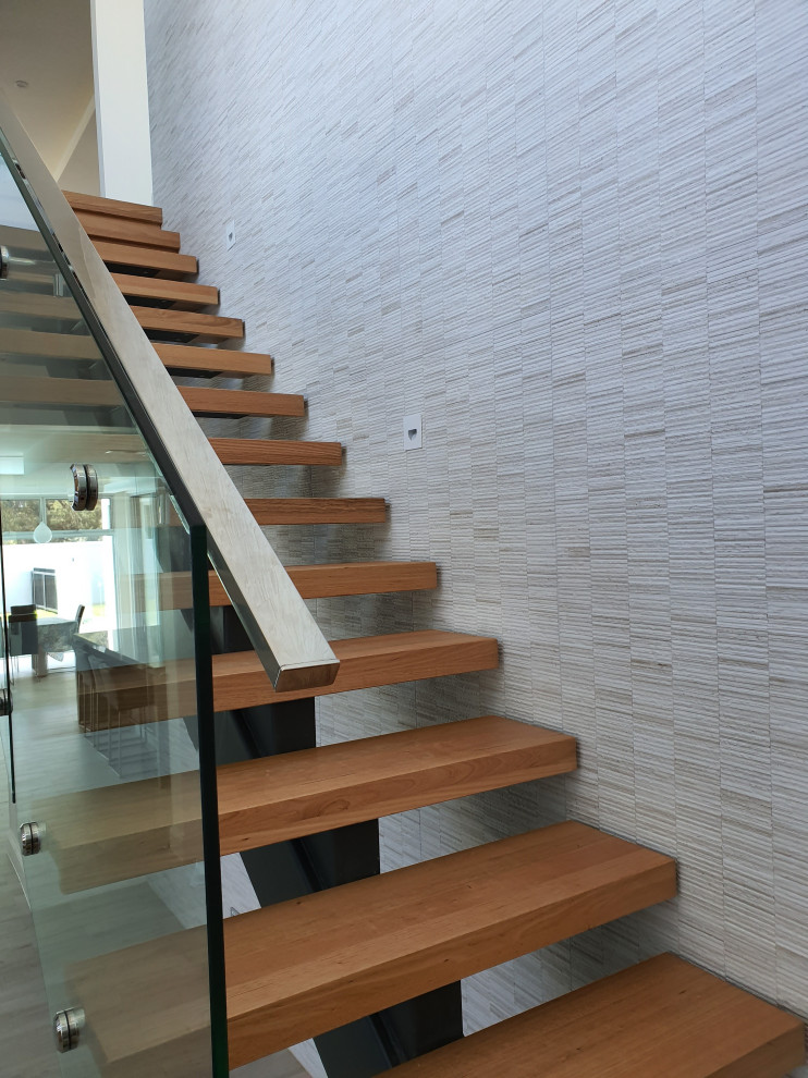 Mid-sized contemporary wood l-shaped staircase in Adelaide with open risers and glass railing.