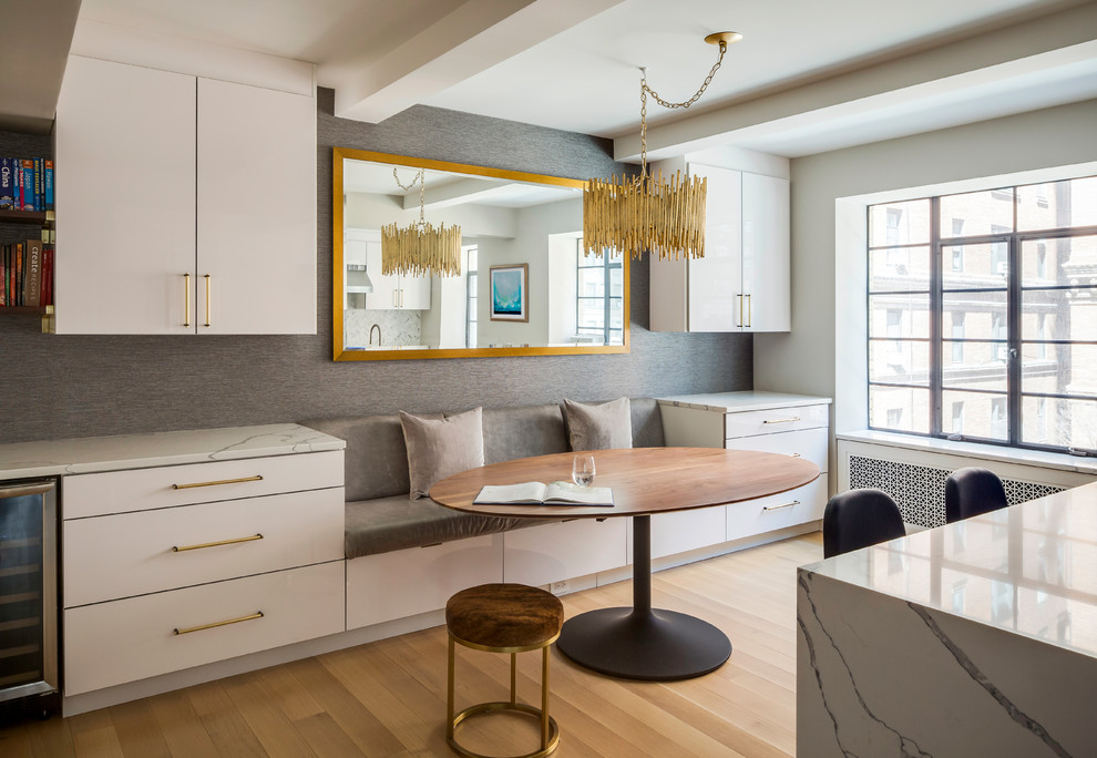 Inspiration for a contemporary light wood floor and beige floor dining room remodel in New York with gray walls