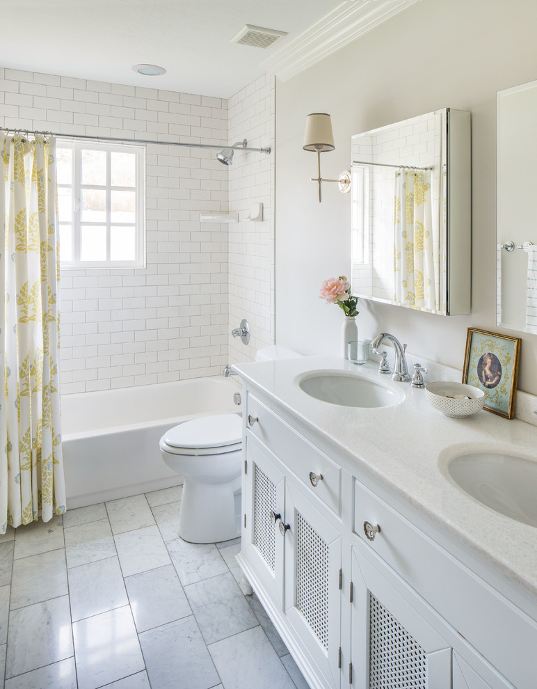 Photo of a traditional bathroom in Salt Lake City with an undermount sink, recessed-panel cabinets, white cabinets, an alcove tub, a shower/bathtub combo, white tile, subway tile and white floor.