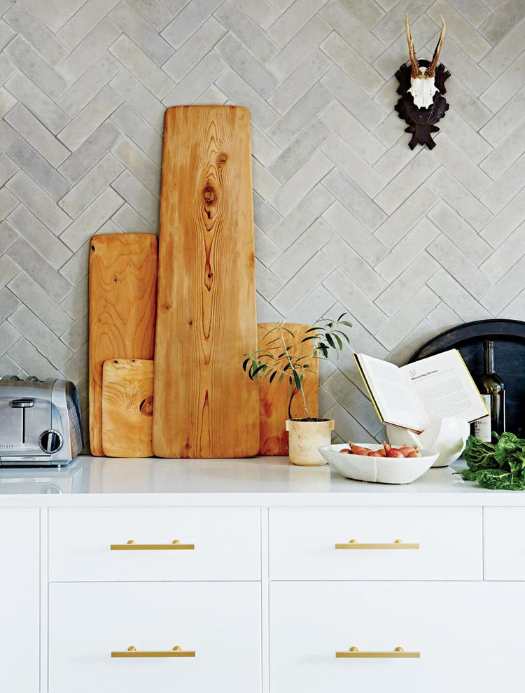 Kitchen - transitional kitchen idea in Boise with flat-panel cabinets, white cabinets, solid surface countertops, gray backsplash and stone tile backsplash