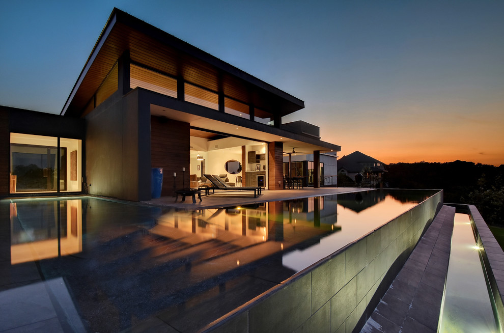This is an example of a contemporary two-storey exterior in Austin with a flat roof.