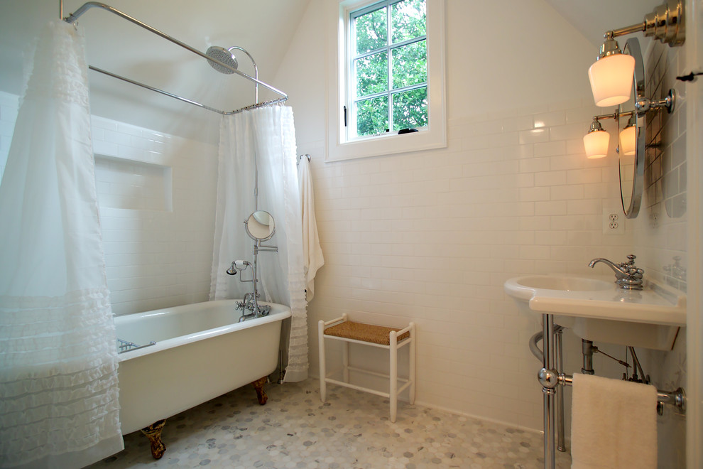 This is an example of a traditional bathroom in DC Metro with a claw-foot tub, mosaic tile and a console sink.