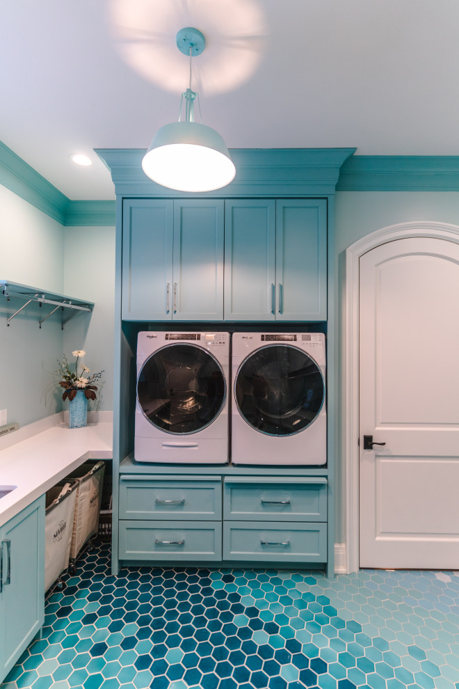 Photo of a large bohemian u-shaped utility room in Chicago with a submerged sink, flat-panel cabinets, blue cabinets, engineered stone countertops, blue walls, ceramic flooring, an integrated washer and dryer, blue floors, white worktops and tongue and groove walls.