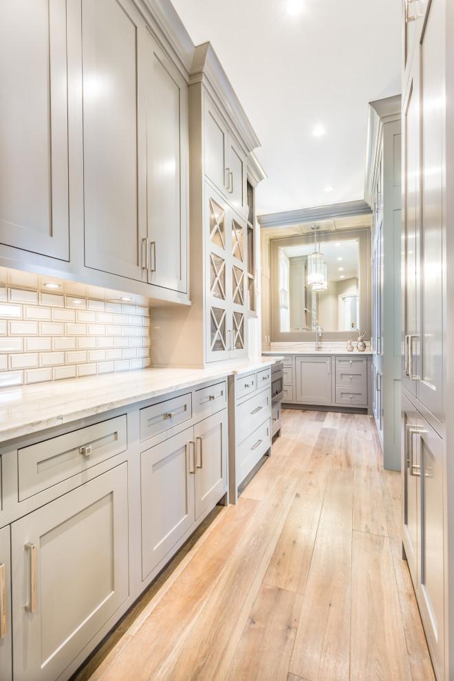 Example of a transitional galley kitchen pantry design with flat-panel cabinets and gray cabinets