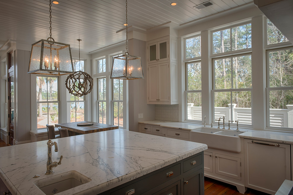 This is an example of a large country u-shaped eat-in kitchen in Atlanta with shaker cabinets, white cabinets, onyx benchtops, white splashback, stone tile splashback, panelled appliances, medium hardwood floors, with island and a farmhouse sink.