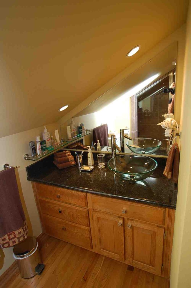 This is an example of a small traditional 3/4 bathroom in Boise with an undermount sink, raised-panel cabinets, light wood cabinets, granite benchtops, an alcove shower, brown tile, ceramic tile, beige walls and light hardwood floors.