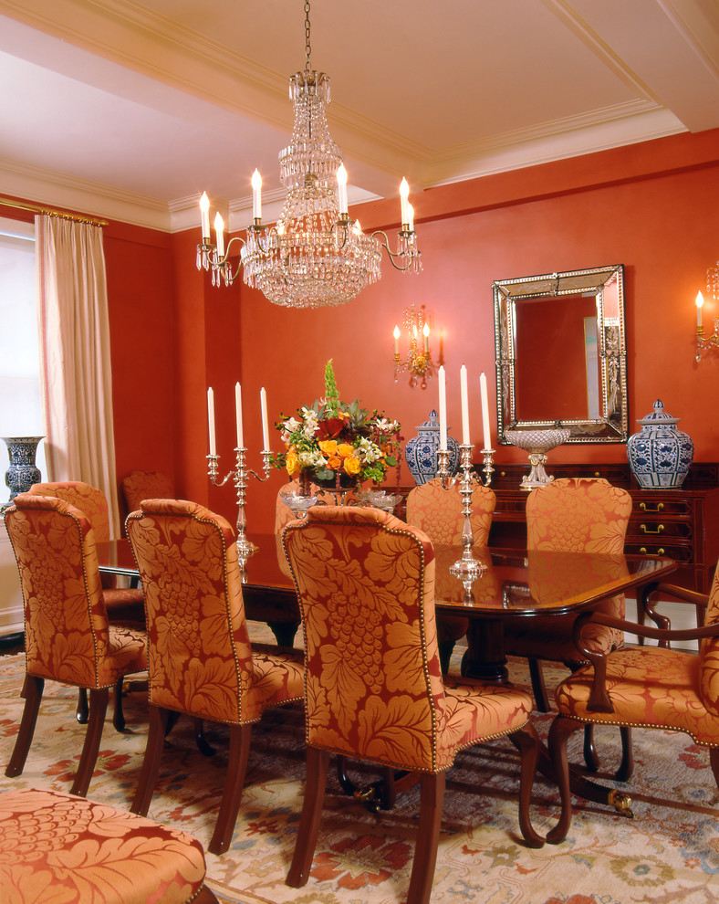 Design ideas for a traditional dining room in New York with orange walls.