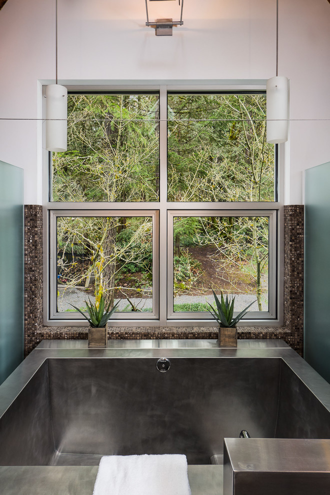Photo of a mid-sized industrial master bathroom in Seattle with a japanese tub, a curbless shower, a wall-mount toilet, brown tile, mosaic tile, brown walls, slate floors and a wall-mount sink.