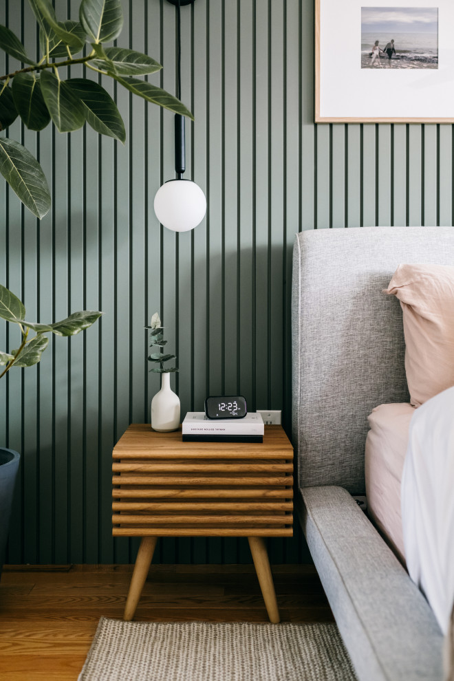 トロントにある中くらいなミッドセンチュリースタイルのおしゃれなロフト寝室 (緑の壁、淡色無垢フローリング、黄色い床、パネル壁)
