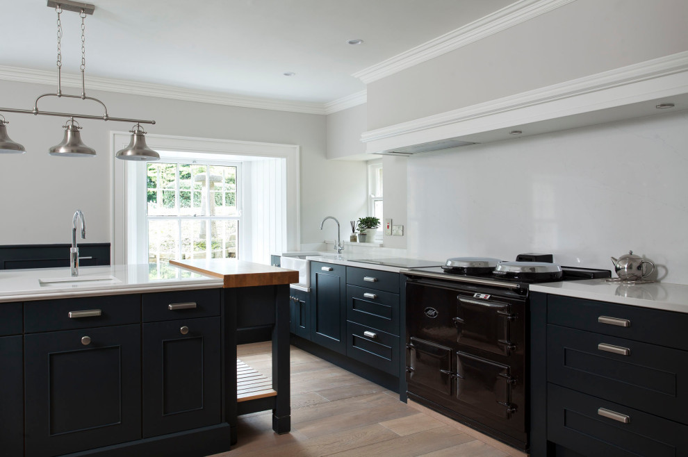 Photo of a large traditional u-shaped kitchen in Other with shaker cabinets and black cabinets.