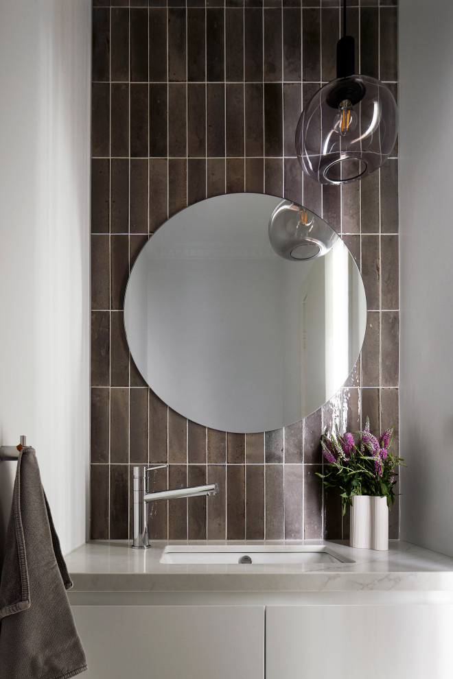 Photo of a small contemporary powder room in Melbourne with flat-panel cabinets, white cabinets, brown tile, ceramic tile, an undermount sink, engineered quartz benchtops and a built-in vanity.