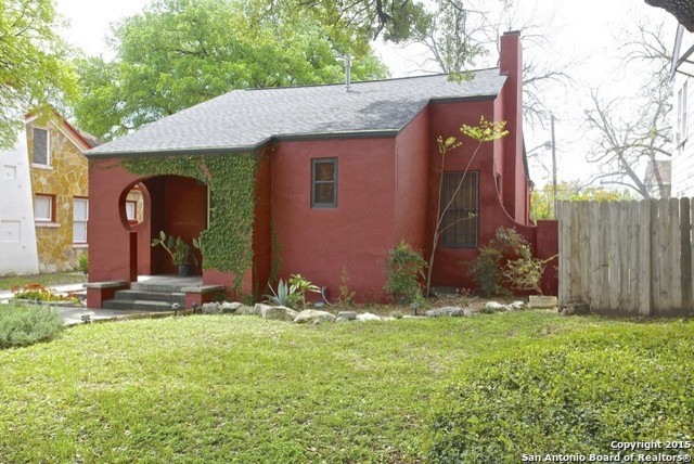 Photo of a small mediterranean one-storey stucco red exterior in Austin.