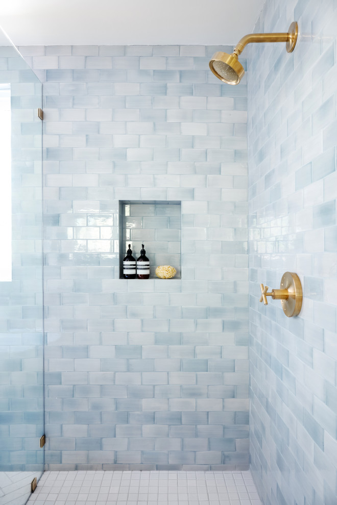 This is an example of a mid-sized modern master bathroom in Los Angeles with a corner shower, blue tile, ceramic tile, a hinged shower door and a built-in vanity.