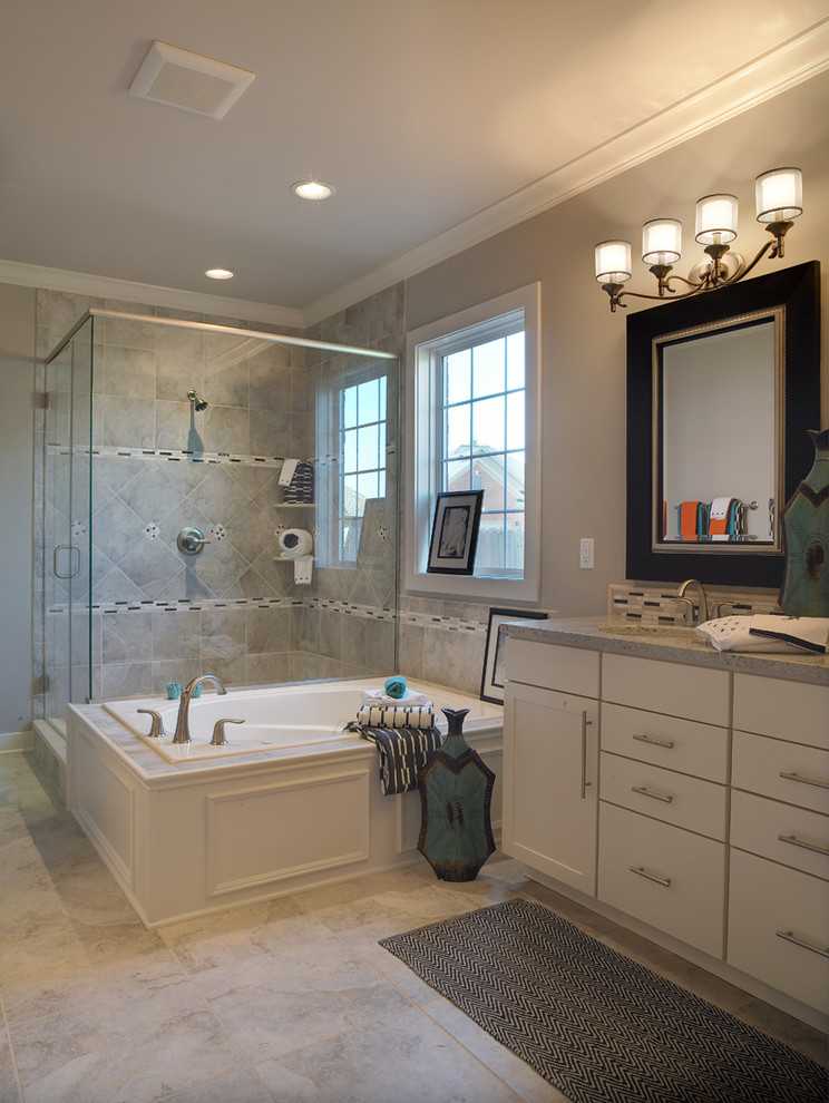 Mid-sized transitional master gray tile and ceramic tile ceramic tile drop-in bathtub photo with shaker cabinets, white cabinets, an undermount sink, granite countertops, gray walls and a one-piece toilet