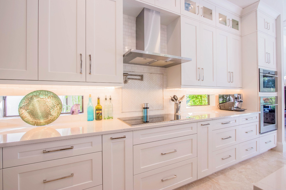 Inspiration for a huge transitional l-shaped porcelain tile and beige floor open concept kitchen remodel with a farmhouse sink, shaker cabinets, white cabinets, quartz countertops, white backsplash, porcelain backsplash, stainless steel appliances and two islands