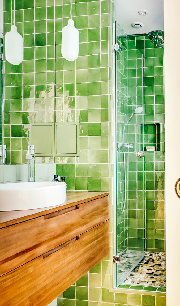This is an example of a small transitional master bathroom in Paris with an undermount tub, an alcove shower, green tile, terra-cotta tile, green walls, light hardwood floors, a drop-in sink, wood benchtops, brown floor, a hinged shower door and brown benchtops.